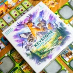 Keystone North America 2nd Edition box and cards laid out showing ecosystem board